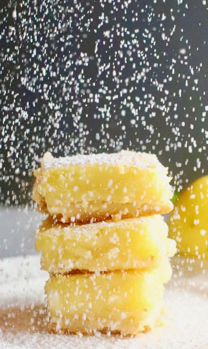 Confectioner's sugar being sifted on Luscious Southern Meyer Lemon Bars