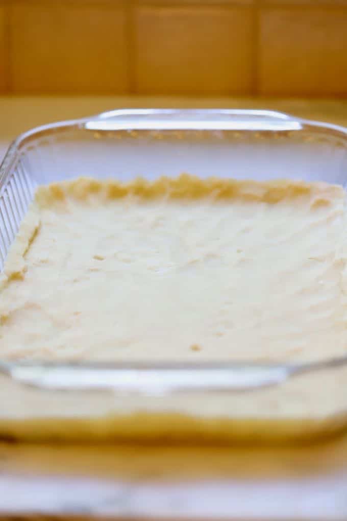 Flattening the cookie dough crust for Luscious Southern Meyer Lemon Bars