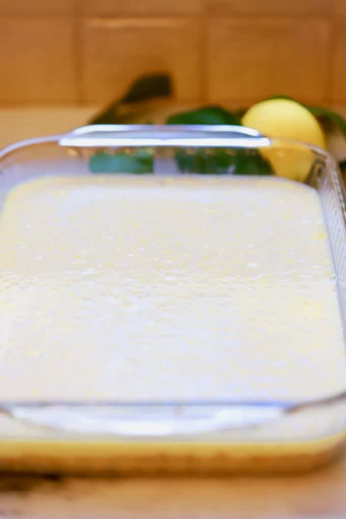 Adding the lemon filling to the cookie crust for Luscious Southern Meyer Lemon Bars