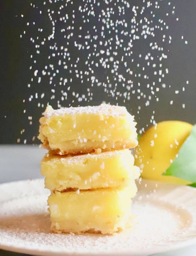 Luscious Southern Meyer Lemon Bars being covered with confectioner's sugar