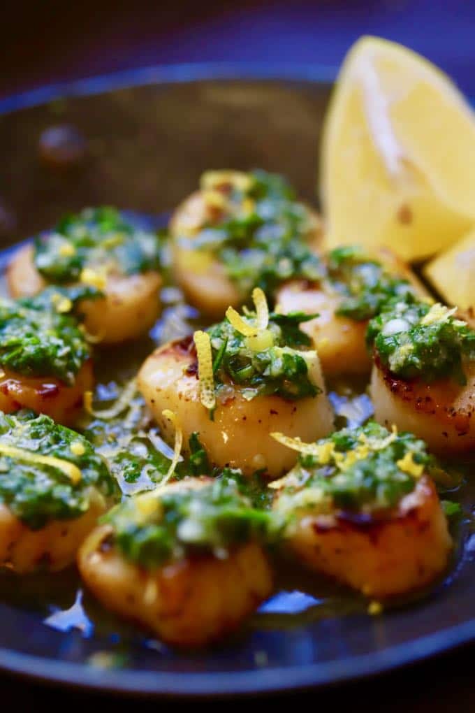 Close up of Pan Seared Scallops topped with Salsa Verde and ready to serve