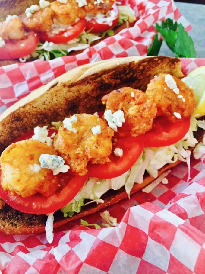 Spicy Shrimp Po' Boy Sandwiches topped with blue cheese crumbles