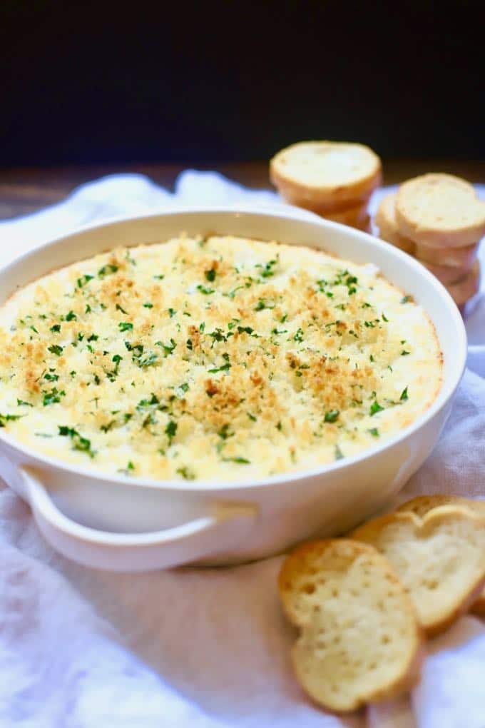 Hot and Cheesy Baked Shrimp Scampi Dip with toasted bread rounds ready for serving