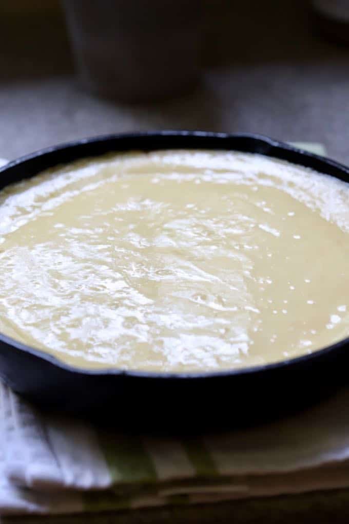 Cake batter in a cast iron skillet ready to bake. 