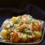 Easy Shrimp and Pineapple Fried Rice on a copper plated garnished with parsley