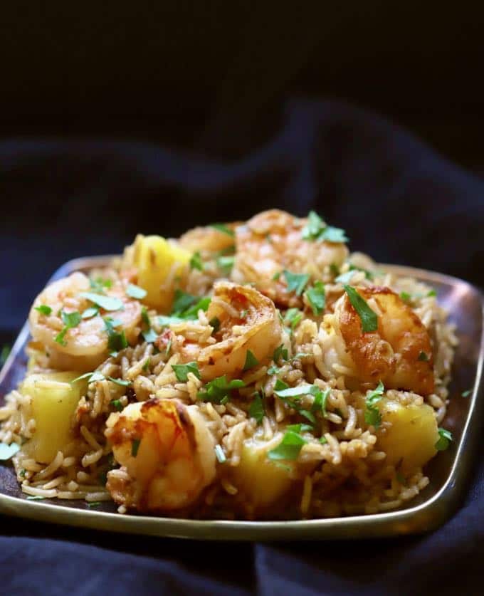 Easy Shrimp and Pineapple Fried Rice on a copper plated garnished with parsley