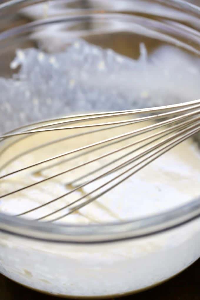 Whisking milk, baking powder, and flour to make a batter for boxty.