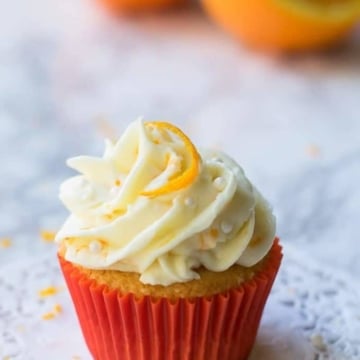 Orange cupcake with orange cream cheese icing and a orange slice on top