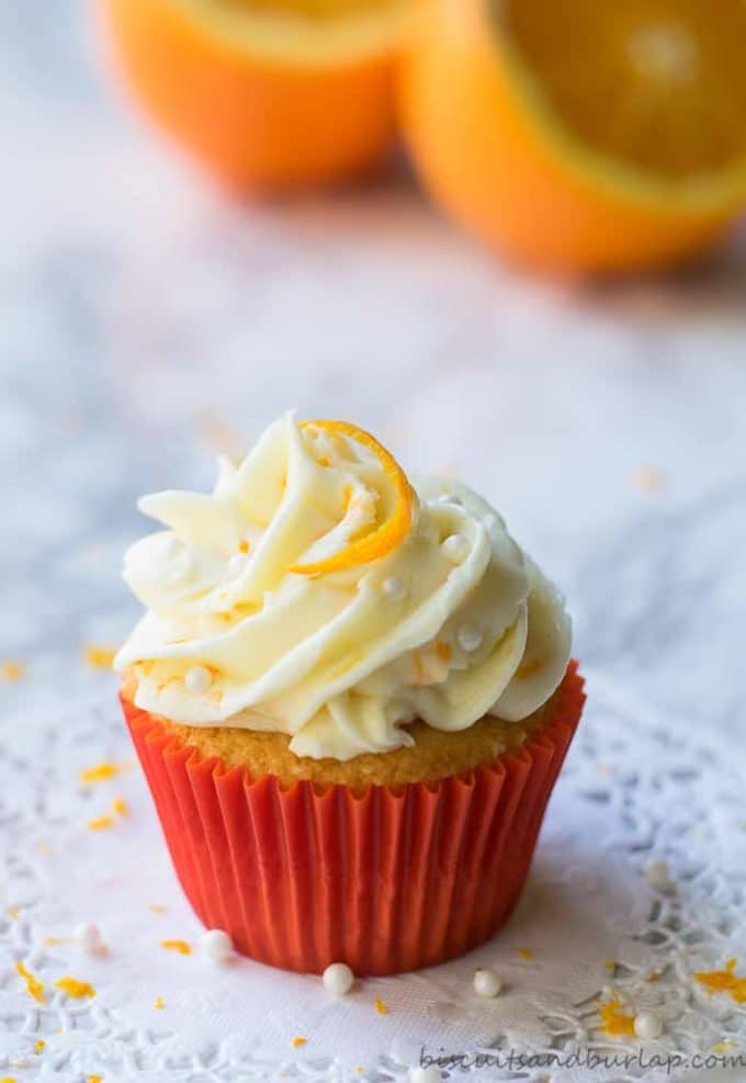 Orange cupcake with orange cream cheese icing and a orange slice on top