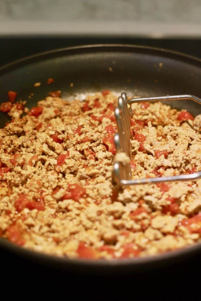 Cooking ground turkey in a skillet.