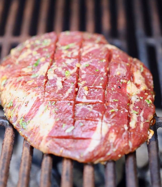 Flank steak on a grill for Ultimate Grilled Flank Steak