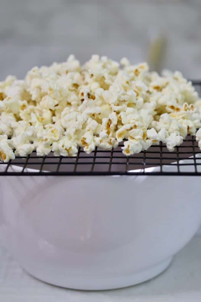 Separating the popcorn from unpopped kernels for Caramel Corn with Dark Chocolate Drizzle 