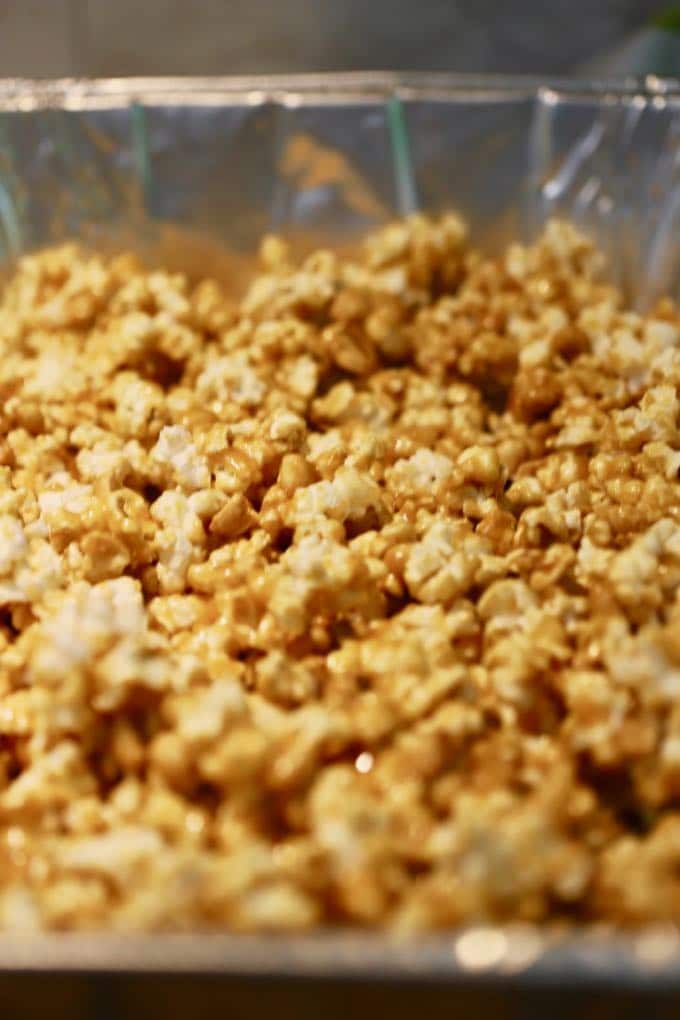 Caramel corn in a large disposable aluminum pan ready to bake for Caramel Corn with Dark Chocolate Drizzle