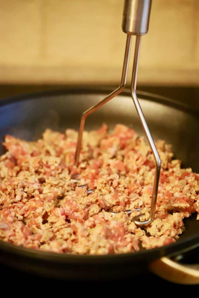 Cooking sausage in a skillet for Easy Supreme Pizza Casserole