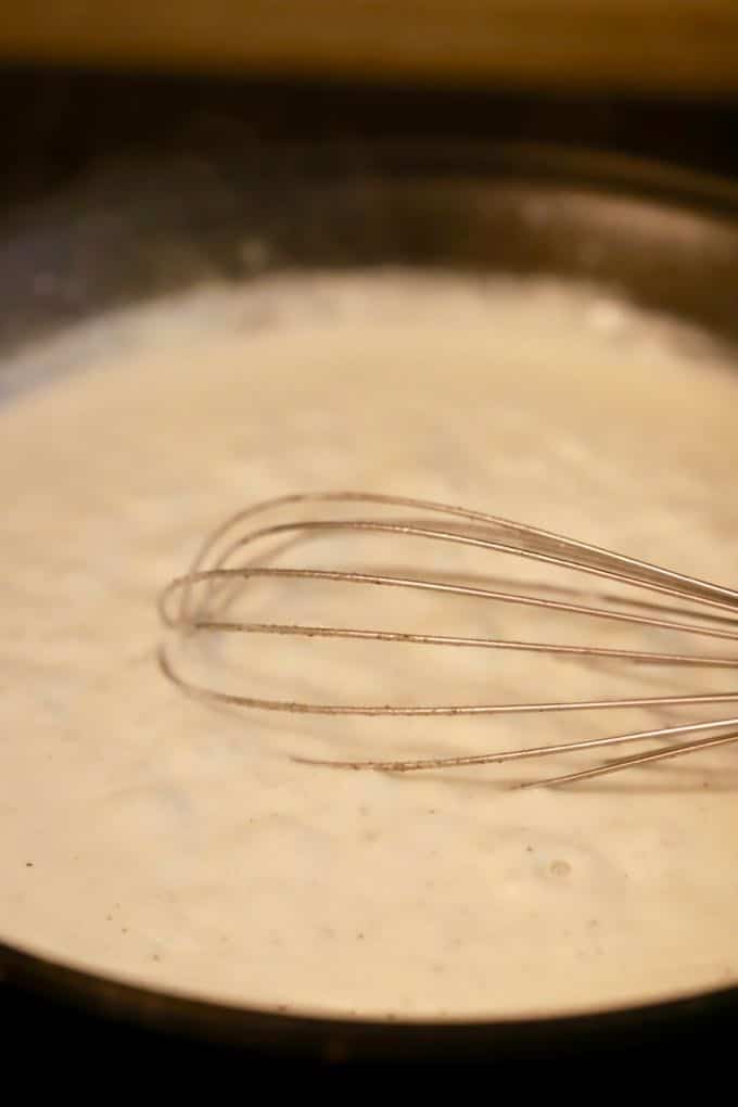 Making a white sauce in a skillet for Easy Supreme Pizza Casserole
