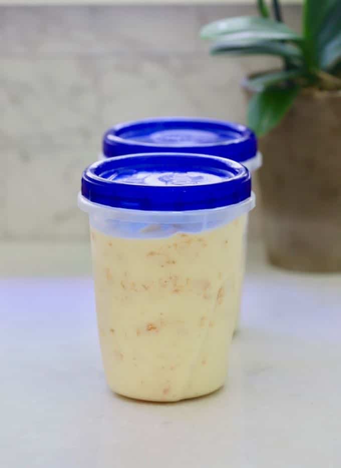 Homemade Fresh Peach Ice Cream in airtight containers ready for the freezer 