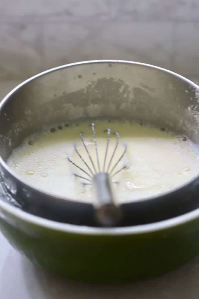 Cooling the cooked custard mixture in a large bowl placed in another large bowl of ice for Homemade Fresh Peach Ice Cream