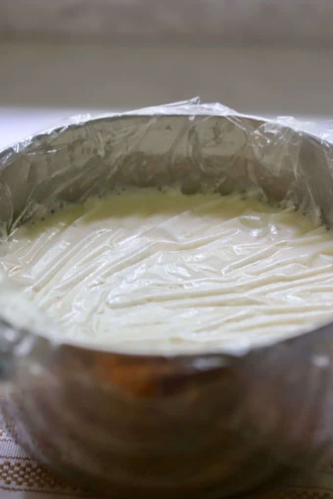 Covering the custard mixture with a large sheet of plastic wrap before placing it in the refrigerator to make Homemade Fresh Peach Ice Cream