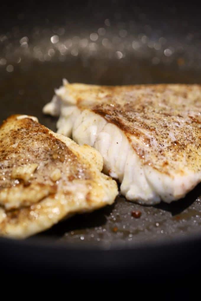 Pan fried fish (grouper fillet) in a skillet for Pan Fried Fish with Blistered Tomatoes
