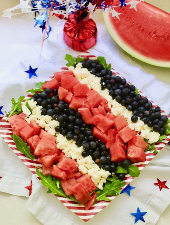 Red, White, and Blue Summer Fruit Salad with watermelon and 4th of July decorations