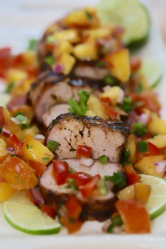 Grilled Pork Tenderloin with Peach Salsa on a white serving platter