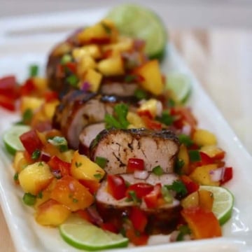 Grilled Pork Tenderloin sliced on a white plate