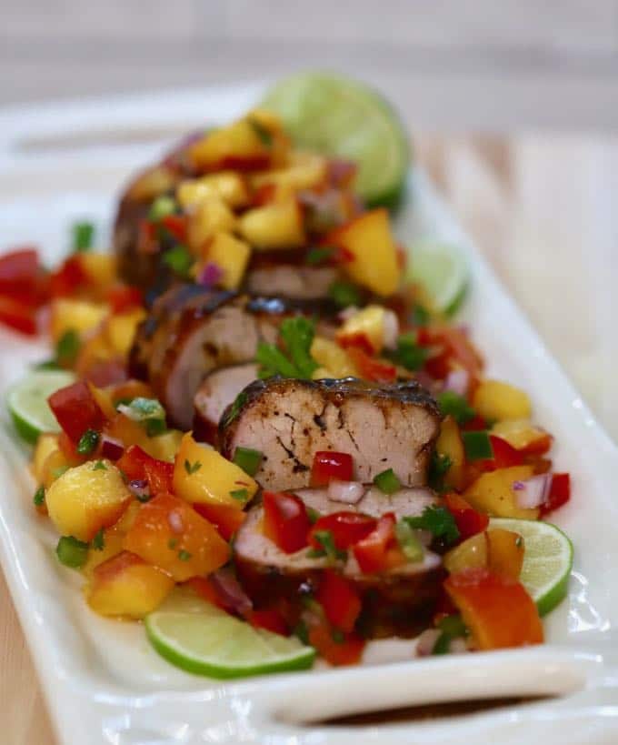 Grilled Pork Tenderloin sliced on a white plate