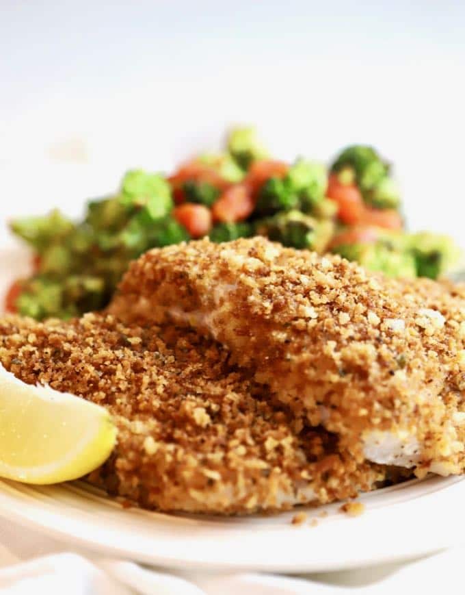 Easy Crispy Oven Baked Grouper fillets on a plate with broccoli and tomatoes