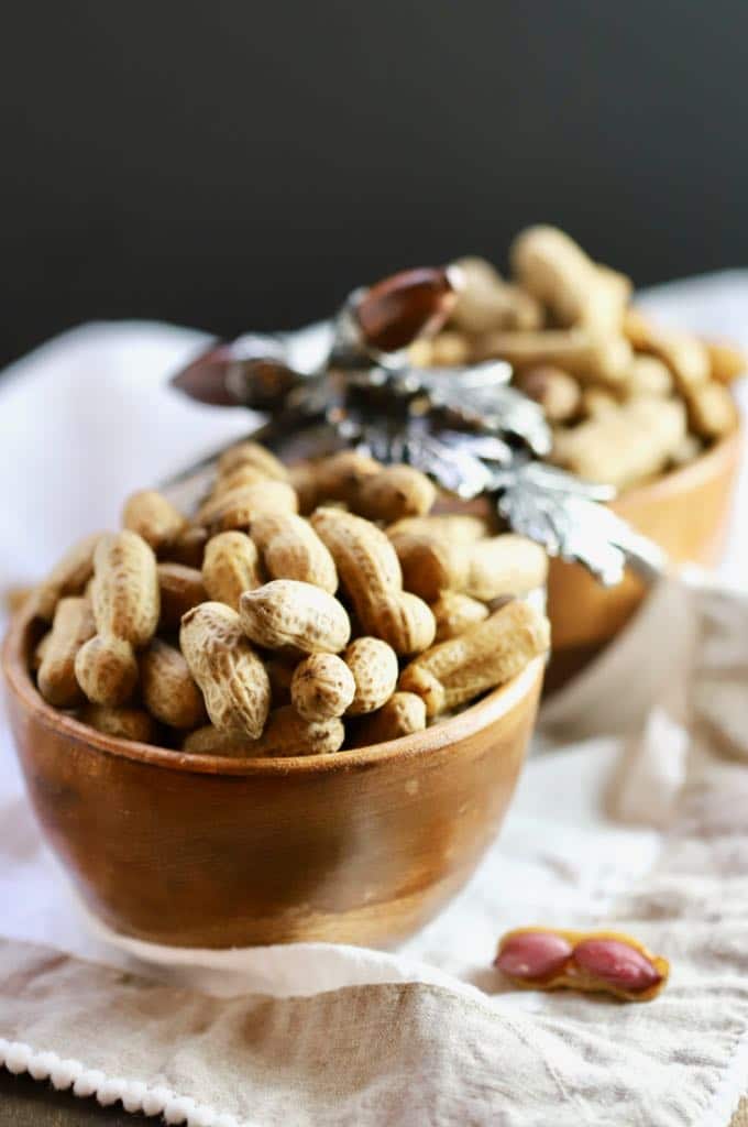 A wooden bowl filled with Easy Southern Boiled Peanuts