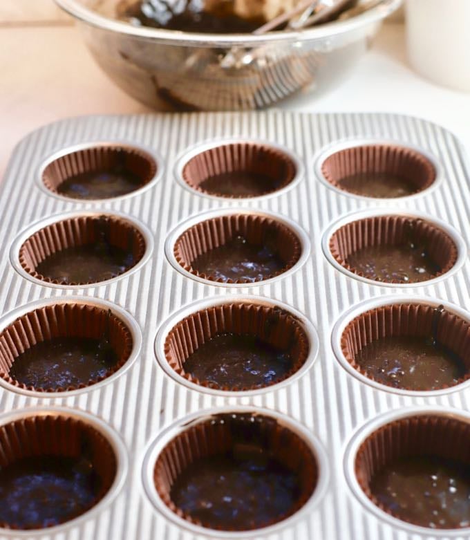 Muffin pan with liners and cupcake batter for Easy Chocolate Halloween Cupcakes and Icing