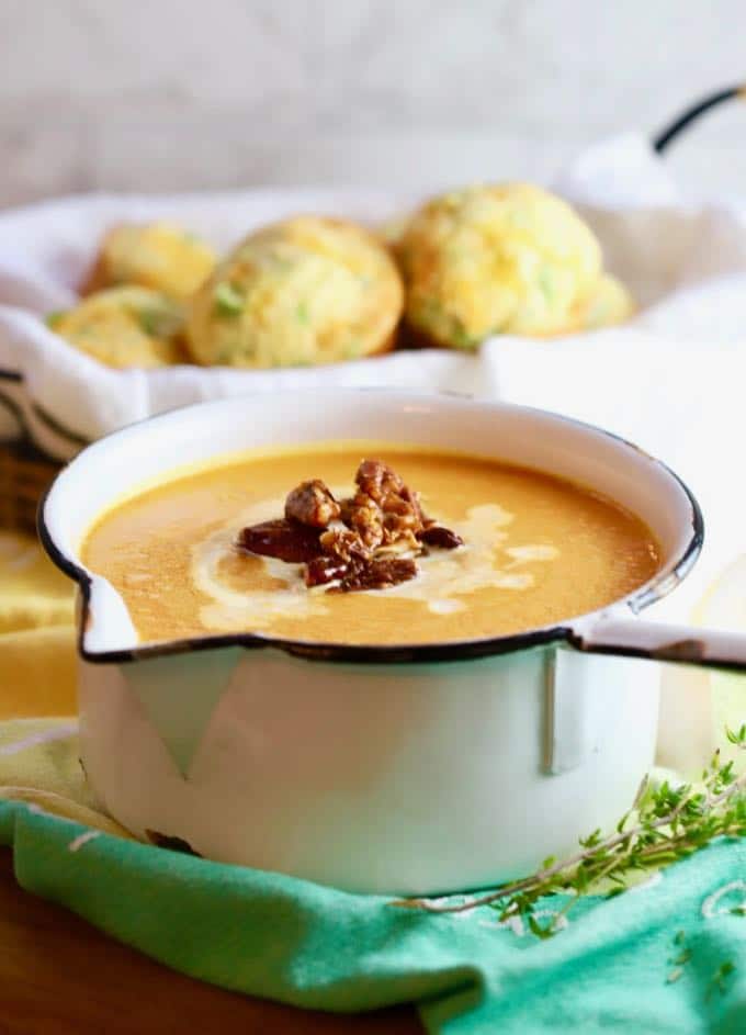 Easy Creamy Southern Sweet Potato Soup in a white pan with muffins in background