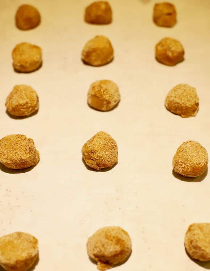 Old Fashioned Crunchy Gingersnap Cookie dough on a parchment lined baking sheet ready to bake