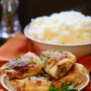 A plate full ofSouthern Crispy Oven Fried Chicken with a bowl of mashed potatoes