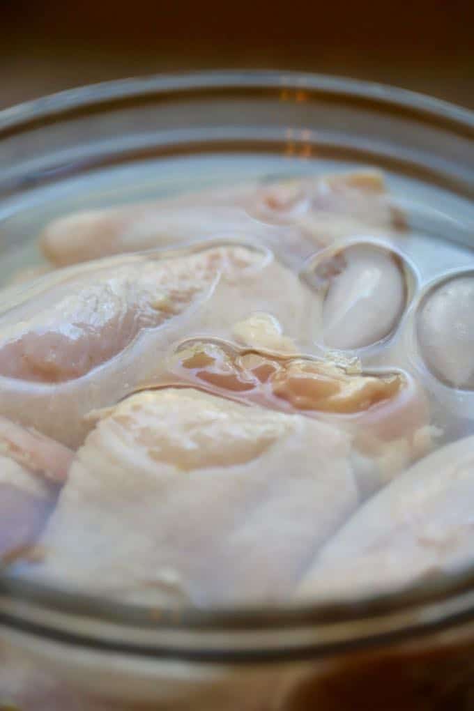 Brining chicken pieces in water and salt for Southern Crispy Oven Fried Chicken