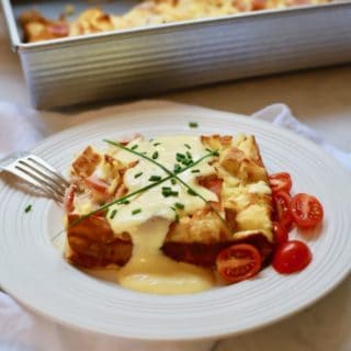 Easy Eggs Benedict Casserole on a white plate with Blender Hollandaise Sauce