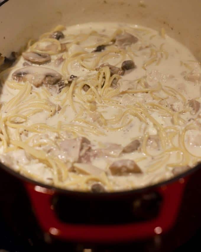Spaghetti, mushrooms, turkey and sauce cooking for Easy Leftover Turkey Tetrazzini