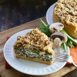A slice of Green Bean Pie with Ritz Cracker Crust garnished with fresh mushrooms and green beans
