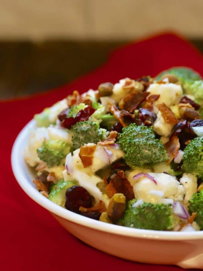 Broccoli Cauliflower Salad with Cranberries in a white serving bowl.