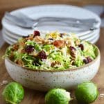 Brussel Sprouts Salad with Citrus Vinaigrette topped with bacon and parmesan cheese.