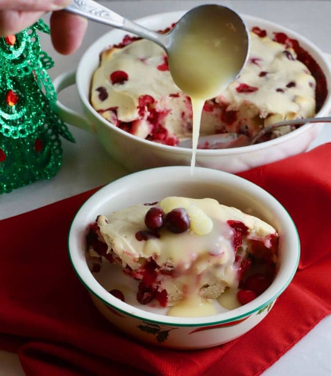 Cranberry Cake with Hard Sauce on a red napkin in a Christmas bowl.