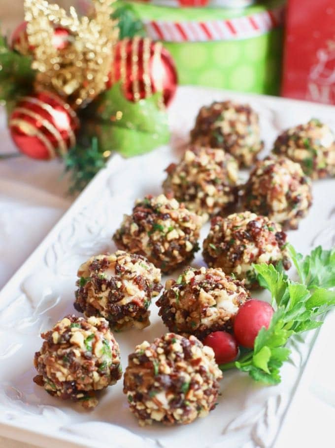 A dozen Cranberry Pecan Mini-Goat Cheese Balls garnished with parsley and cranberries.