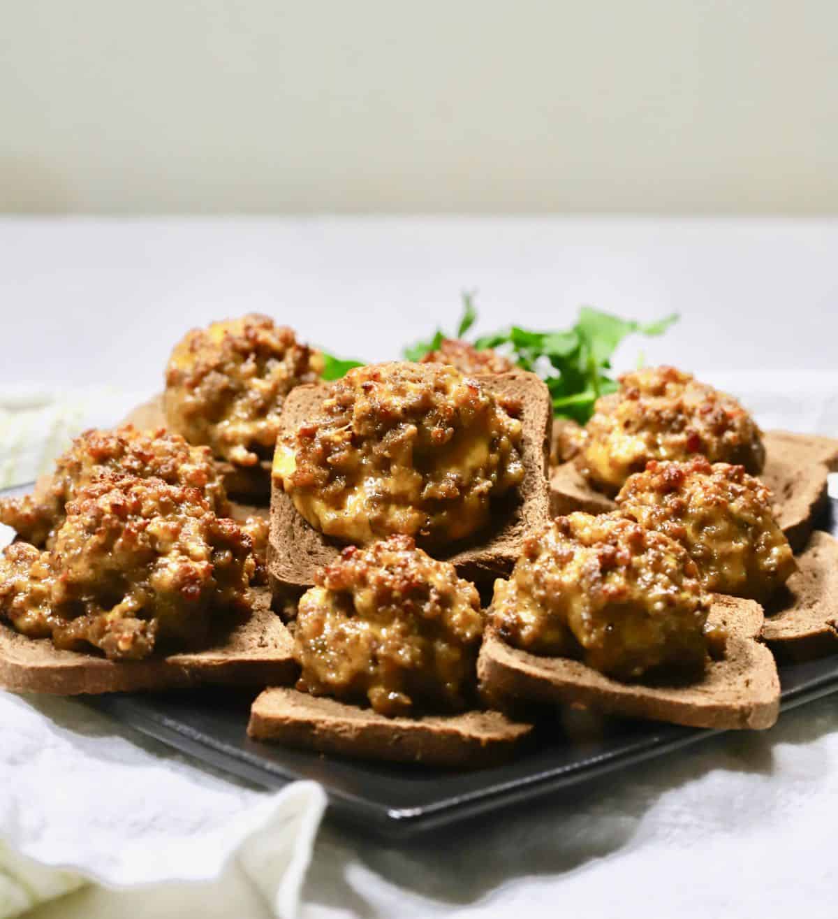 A black plate with hanky panky appetizers.