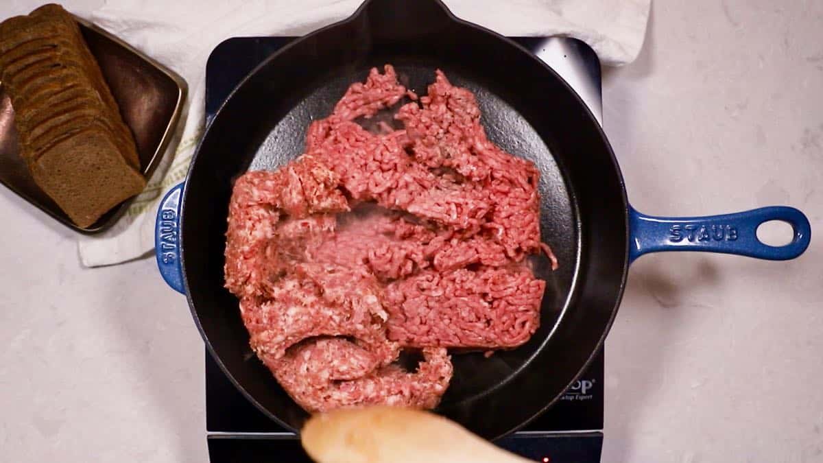 Ground beef and sausage in a skillet. 