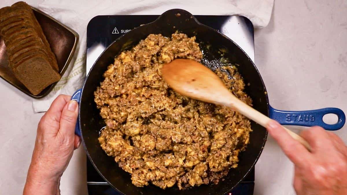 Ground beef with melted cheese in a skillet. 