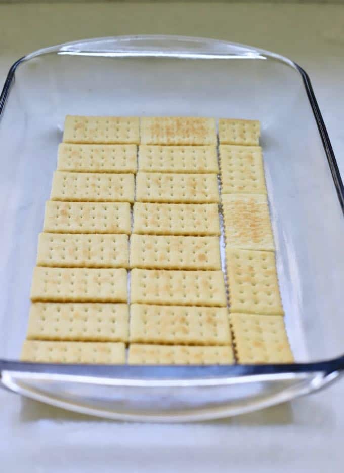 A layer of crackers in a baking dish to make homemade copycat kit kat bars.