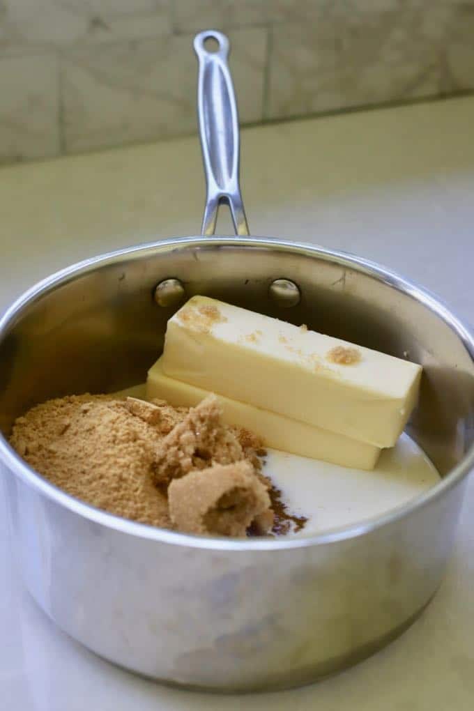 A saucepan with butter, brown sugar and granulated sugar to make homemade kit kat bars.
