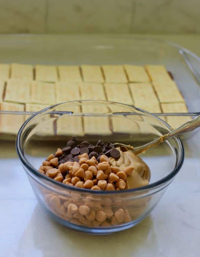 Chocolate and butterscotch chips and peanut butter in a bowl to make homemade copycat kit kat bars.