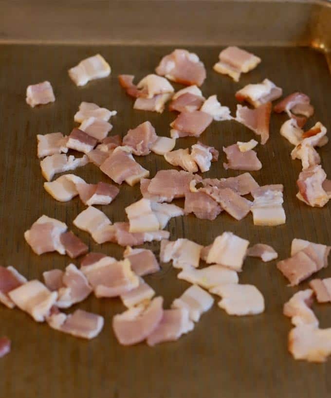 A baking sheet with chopped bacon ready for the oven.