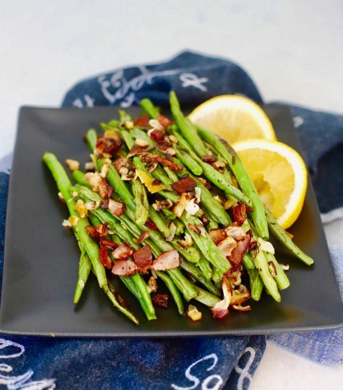 A plate of Roasted Green Beans with Bacon and Lemon.