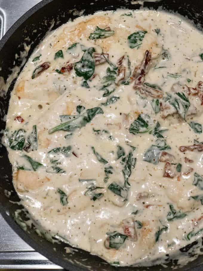 One Pot Creamy Tuscan Chicken in a cast iron skillet